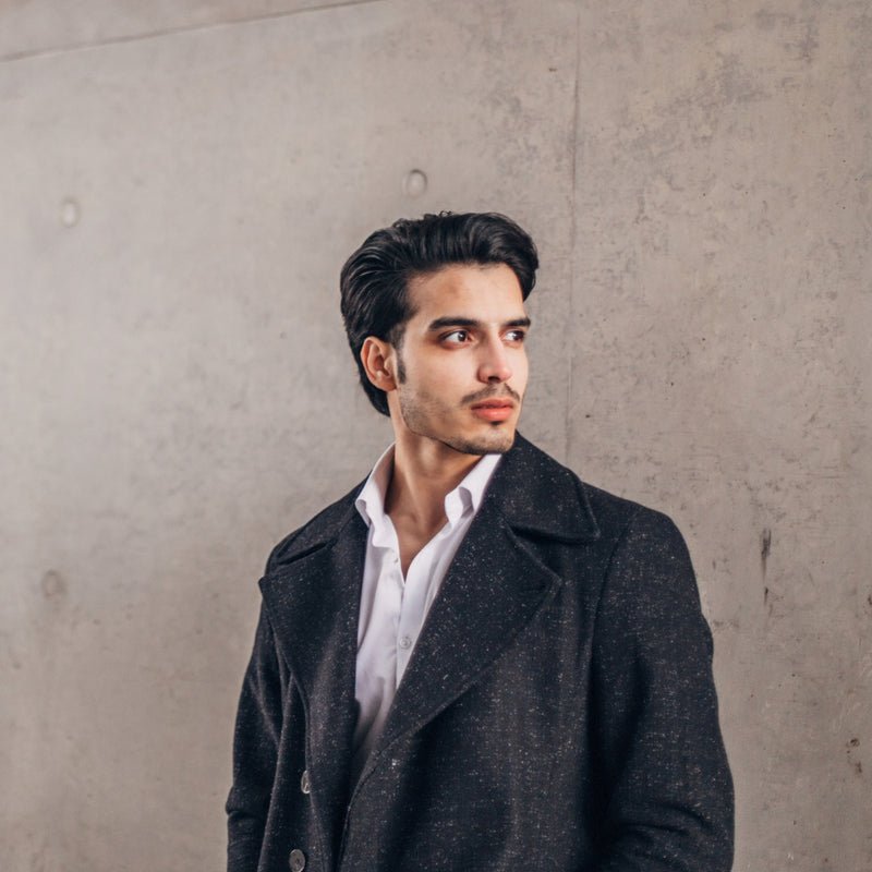 A handsome man wearing a stylish wool overcoat for elegant winter fashion.